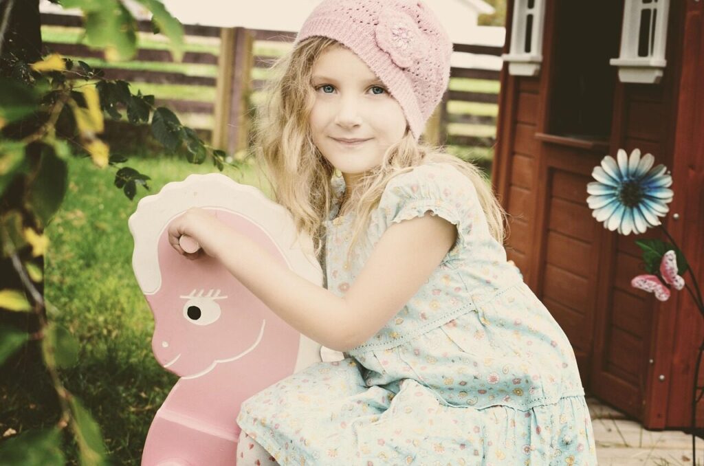 child, girl, model, caucasian, blonde, little girl, girl model, child model, blonde model, caucasian girl, blonde girl, dress, bonnet, playing, rocking horse, young girl, smile, smiling, portrait, child, girl, girl, girl, girl, little girl, little girl, little girl, little girl, little girl, rocking horse, young girl